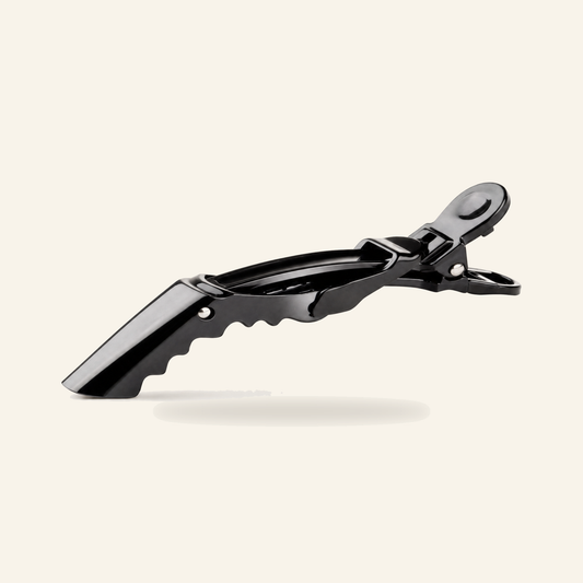 Alligator-Haarspangen 10er-Set Schwarz 10 cm für Salon - Produktfoto auf beigem Hintergrund